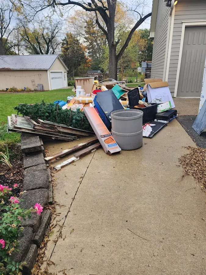 Dumpster being loaded with debris for Roofing Dumpster Rental in Stansbury Park